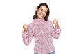 Young caucasian girl wearing wool winter sweater very happy and excited doing winner gesture with arms raised, smiling and