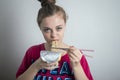 Young caucasian girl woman eating instant noodles ramen with chopsticks Royalty Free Stock Photo