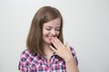 Young caucasian girl woman looks embarrassed, shy, blush or flattered of compliment