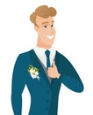 Young caucasian groom giving thumb up.