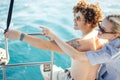 Young couple navigating on a yacht in caribbean sea