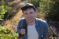 Young caucasian handsome man smiling hiking at forest