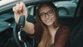 Young caucasian happy woman in front of the new car and holding keys Royalty Free Stock Photo