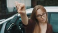 Young caucasian happy woman in front of the new car and holding keys Royalty Free Stock Photo