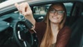 Young caucasian happy woman in front of the new car and holding keys Royalty Free Stock Photo