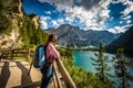 Young caucasian hiker admiring the view of Baires Lake in the Dolomite mountains, South Tirol, Italy Royalty Free Stock Photo