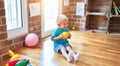 Young caucasian kid playing at kindergarten with toys. Preschooler boy happy at playroom Royalty Free Stock Photo