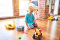 Young caucasian kid playing at kindergarten with toys. Preschooler boy happy at playroom Royalty Free Stock Photo