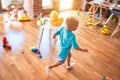 Young caucasian kid playing at kindergarten with toys. Preschooler boy happy at playroom Royalty Free Stock Photo