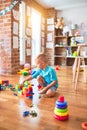 Young caucasian kid playing at kindergarten with toys. Preschooler boy happy at playroom Royalty Free Stock Photo