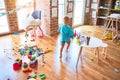 Young caucasian kid playing at kindergarten with toys. Preschooler boy happy at playroom Royalty Free Stock Photo