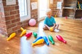 Young caucasian kid playing at kindergarten with toys. Preschooler boy happy at playroom Royalty Free Stock Photo