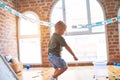 Young caucasian kid playing at kindergarten with toys. Preschooler boy happy at playroom Royalty Free Stock Photo