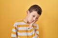 Young caucasian kid standing over yellow background thinking looking tired and bored with depression problems with crossed arms Royalty Free Stock Photo