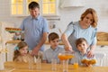 Young caucasian love family with children at table on table in kitchen who Royalty Free Stock Photo