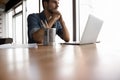 Pensive Caucasian man work on laptop thinking Royalty Free Stock Photo