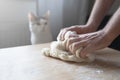 Young Caucasian male hands working the dough near his cat pet Royalty Free Stock Photo