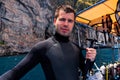 Male scuba diver holding action camera and preparing for diving, Phi Phi Island