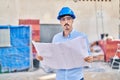 Young caucasian man architect looking house plans at street Royalty Free Stock Photo