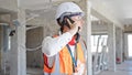 Young caucasian man architect talking on smartphone at construction site Royalty Free Stock Photo