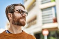 Young caucasian man with beard wearing glasses outdoors on a sunny day Royalty Free Stock Photo