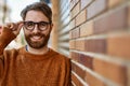 Young caucasian man with beard wearing glasses outdoors on a sunny day Royalty Free Stock Photo