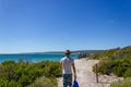 Young caucasian man with a blue bag walking down a pathway to Hamelin Beach. This Beach is famous for his stingrays, Hamelin Beach Royalty Free Stock Photo