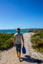 Young caucasian man with a blue bag walking down a pathway to Hamelin Beach. This Beach is famous for his stingrays, Hamelin Beach Royalty Free Stock Photo