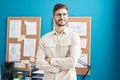 Young caucasian man business worker smiling confident standing with arms crossed gesture at office Royalty Free Stock Photo