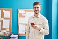 Young caucasian man business worker smiling confident using smartphone at office Royalty Free Stock Photo