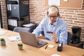 Young caucasian man call center agent using computer holding credit card at office Royalty Free Stock Photo