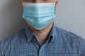 Young Caucasian man in casual wearing medical mask on face