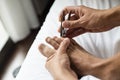 Young caucasian man cutting his toenails