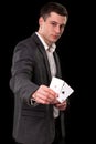 Young caucasian man wearing suit holding two aces in his hand on black background. Gambling concept. Casino Royalty Free Stock Photo