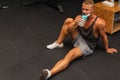 Young caucasian man drinking water after exercise.man in the gym drinking from the shaker