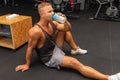 Young caucasian man drinking water after exercise.man in the gym drinking from the shaker