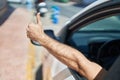 Young Caucasian Man Driving Car Doing Ok Gesture With Thumb Up At Street
