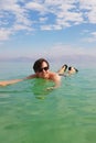 A young caucasian man / guy is floating in the waters of the Dead Sea, the coast of Israel. Wellbeing and relaxing concept. Royalty Free Stock Photo