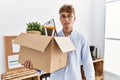 Young caucasian man holding business box thinking attitude and sober expression looking self confident Royalty Free Stock Photo