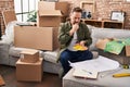 Young caucasian man holding test color looking house plans at new home Royalty Free Stock Photo