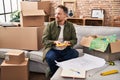 Young caucasian man holding test color looking house plans at new home Royalty Free Stock Photo