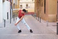 Young caucasian man with long false nails dancing at street, contemporary dance.