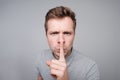 Young caucasian man making silence gesture. Royalty Free Stock Photo