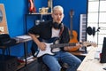 Young caucasian man musician playing electrical guitar at music studio Royalty Free Stock Photo