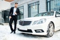 Young caucasian man near his own white executive auto, car Royalty Free Stock Photo