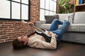 Young caucasian man playing electrical guitar lying on floor at home Royalty Free Stock Photo