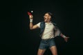 Young caucasian man playing tennis isolated on black studio background in retro style, action and motion concept