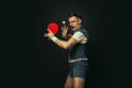 Young caucasian man playing tennis isolated on black studio background in retro style, action and motion concept