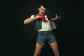 Young caucasian man playing tennis isolated on black studio background in retro style, action and motion concept