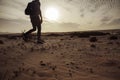 Man with a backpack walking in the desert